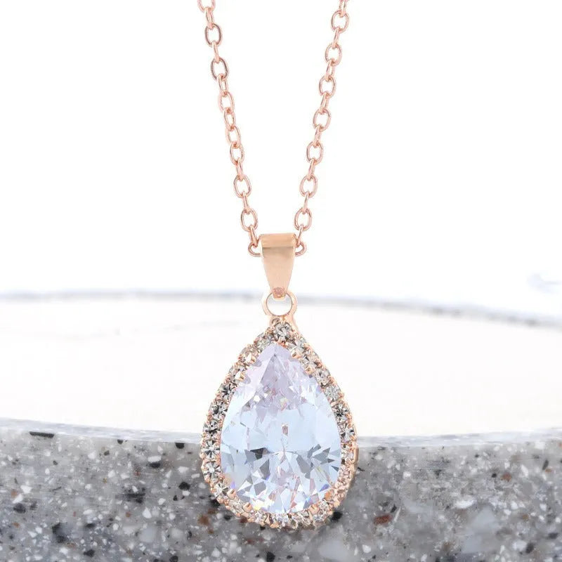 Women's water drop necklace with rose gold rhinestone and pink alloy gemstone pendant.