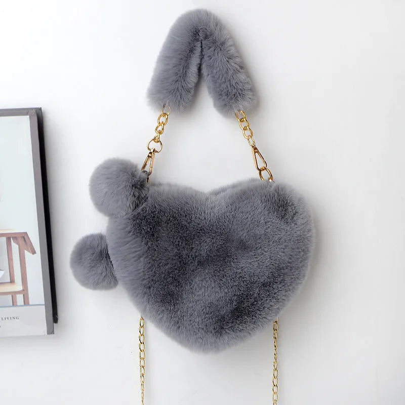 Medium soft plush heart handbag in solid color with zipper closure and shoulder strap option for women