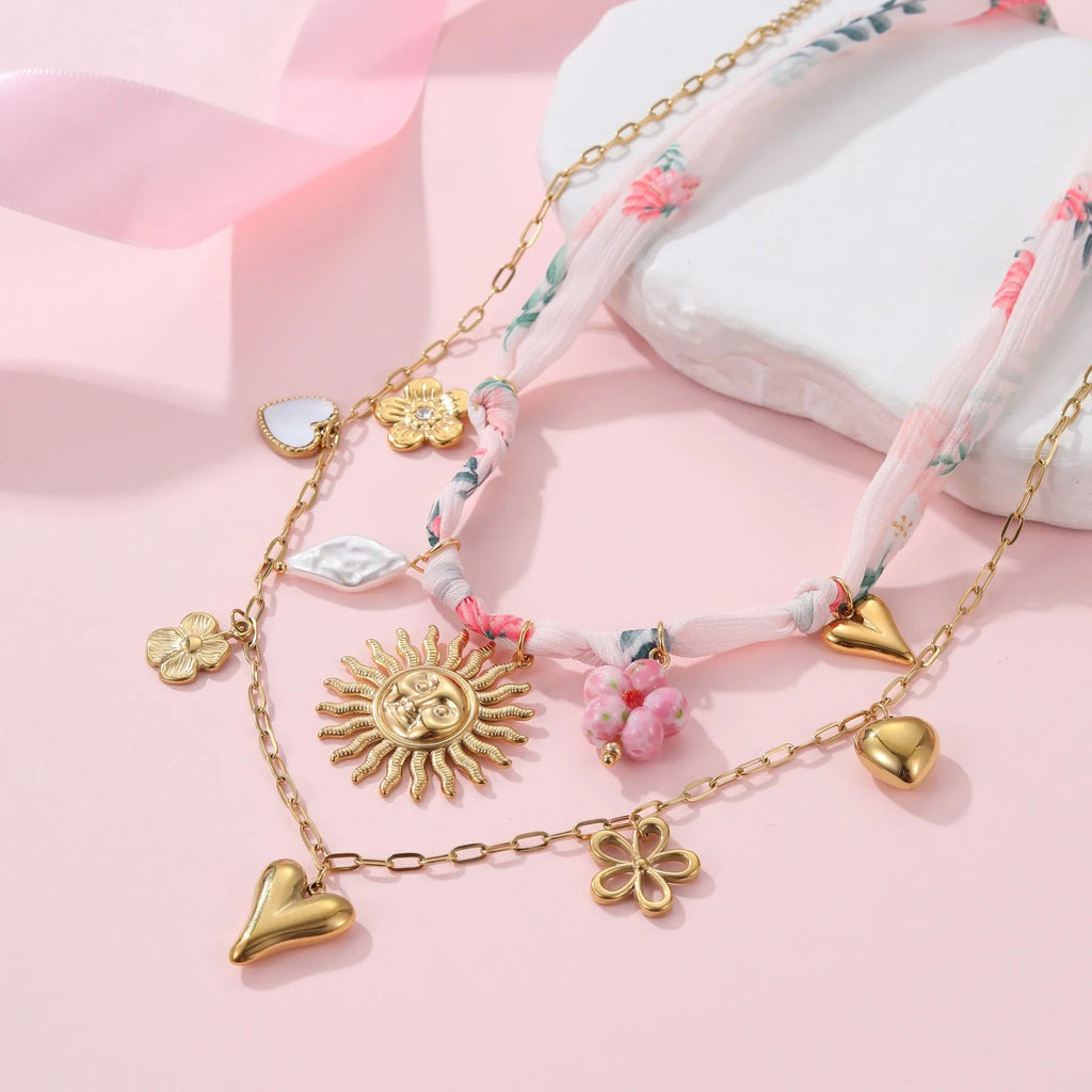 Stainless steel necklace with geometric sun pendant on an adjustable chain.