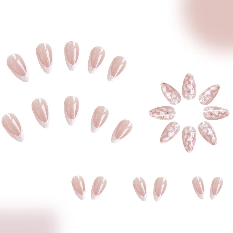 Short almond artificial nail tips with French manicure and glitter flower design in C625 colour
