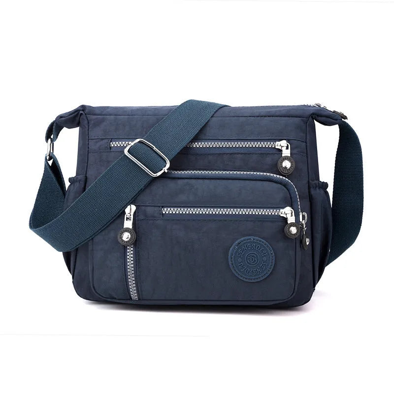 Grey soft nylon messenger bag with single adjustable shoulder strap showing square vertical shape
