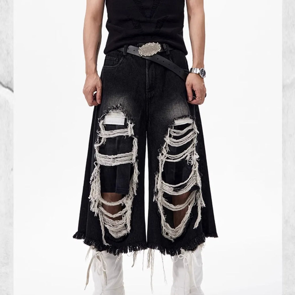 Black women's wide leg cropped jeans with ripped patch detail and a mid-high waist on a hanger.