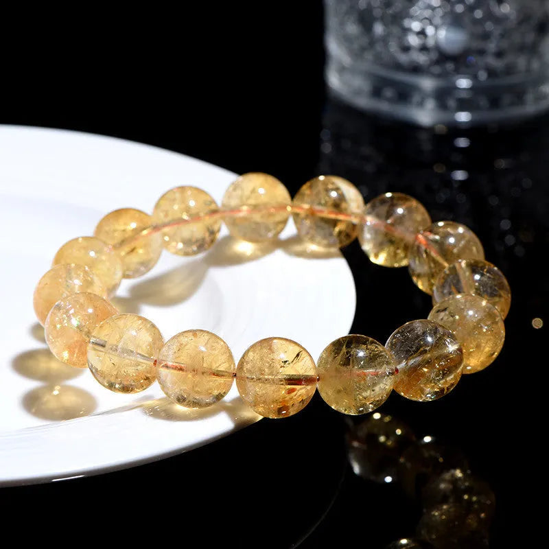 Natural yellow citrine gemstone bracelet showing geometric cut beads on a string.