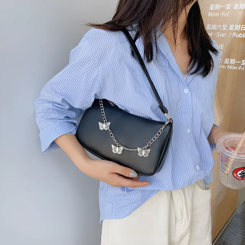 Butterfly chain underarm bag in horizontal square shape with detachable strap and organised interior