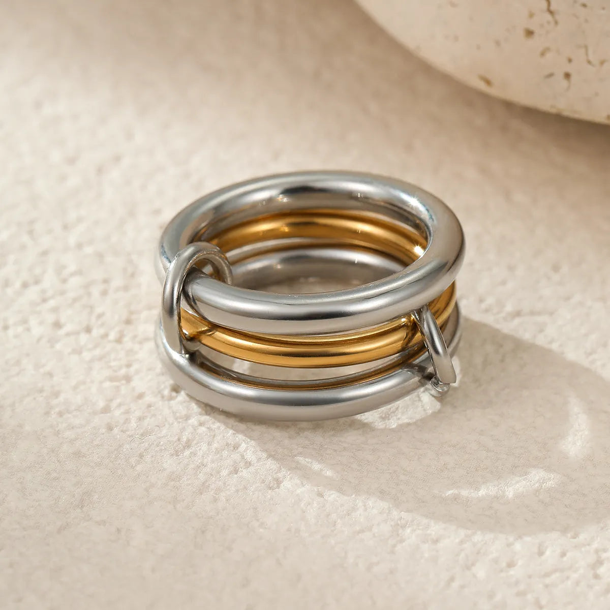 Stacked colour matching stainless steel rings with 18K gold electroplating in exaggerated jewellery styles