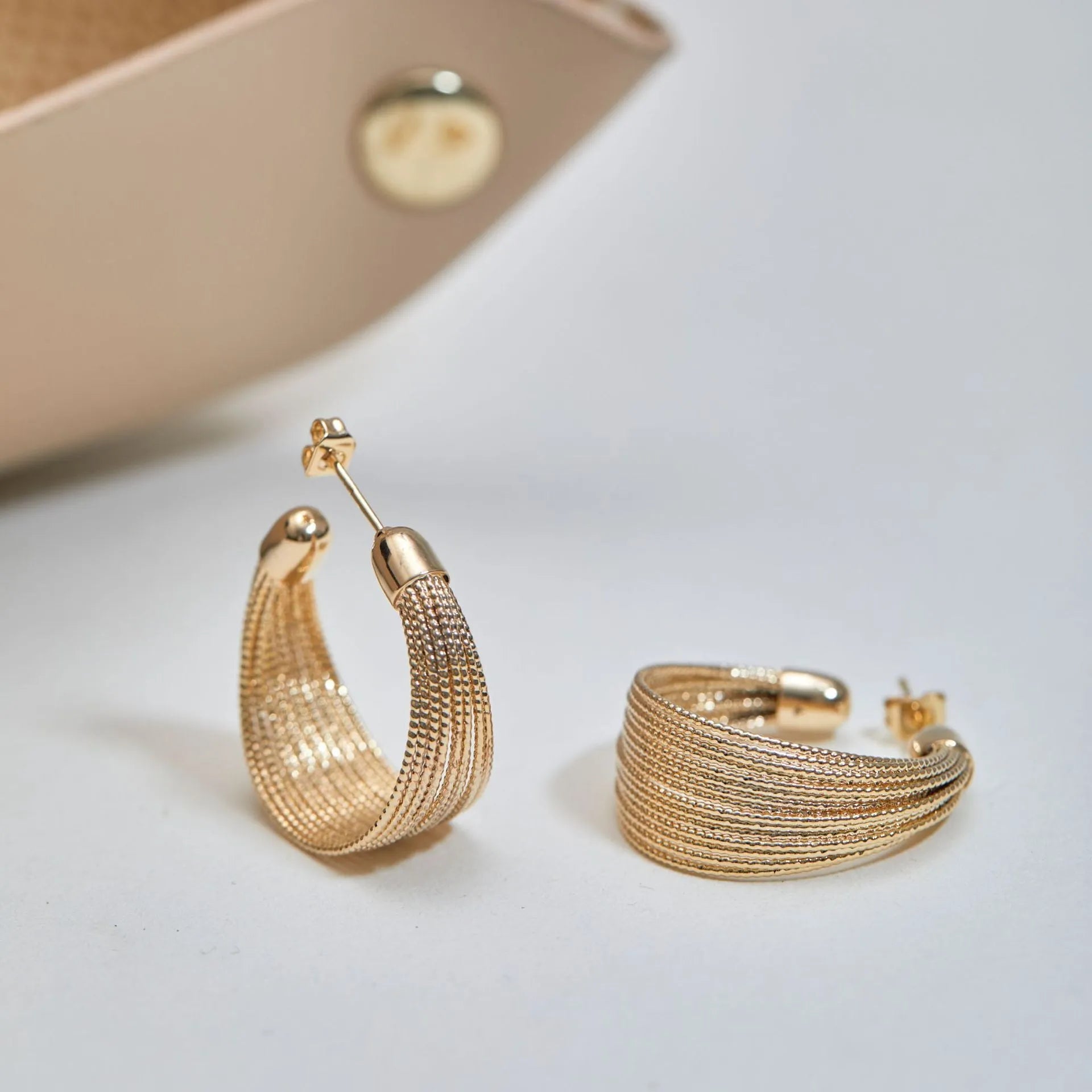 Geometric multi-layer copper earrings with silver or gold electroplated finish, showing stud and clip options