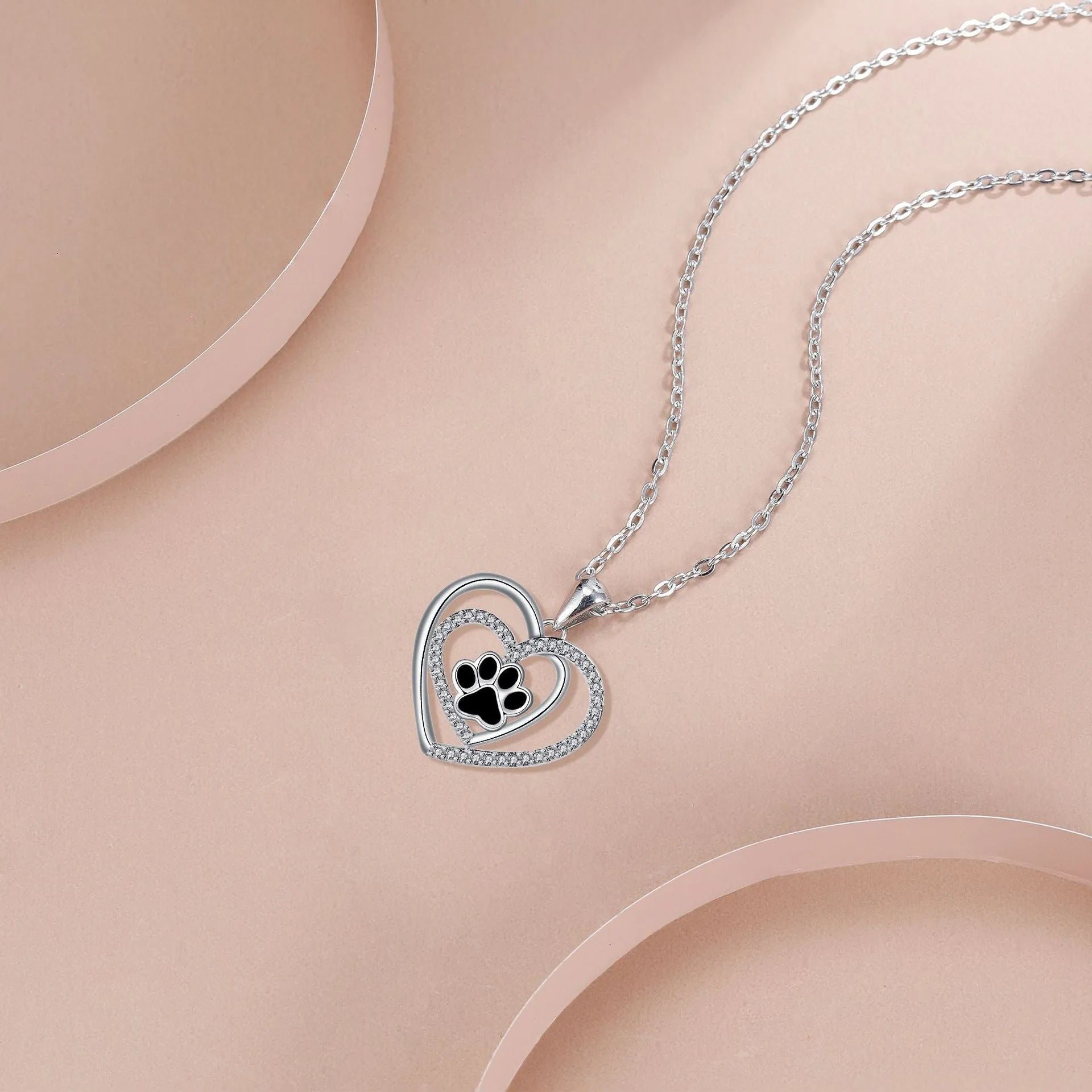 Original design heart-shaped copper necklace with a detailed dog paw print pendant on a cross chain.