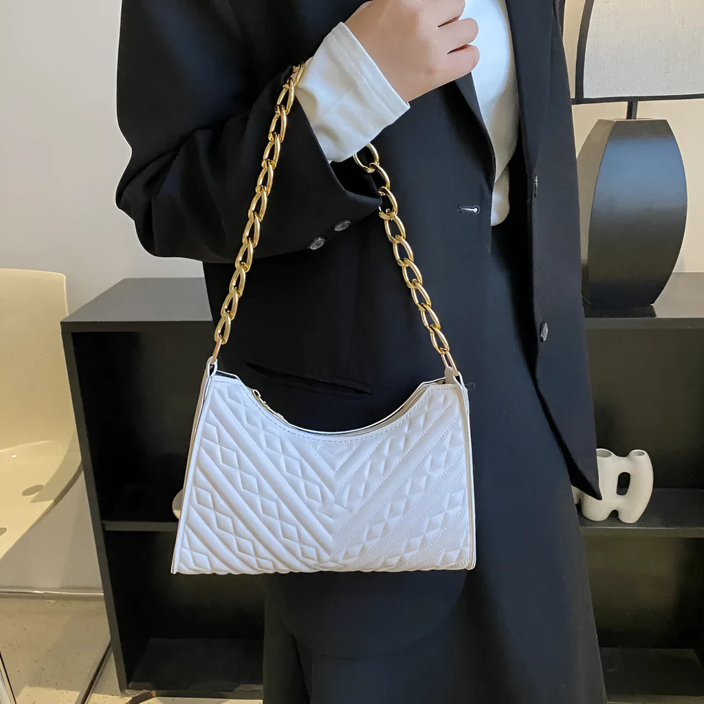 Brown pleated chain baguette shoulder bag with adjustable strap and soft carry handle
