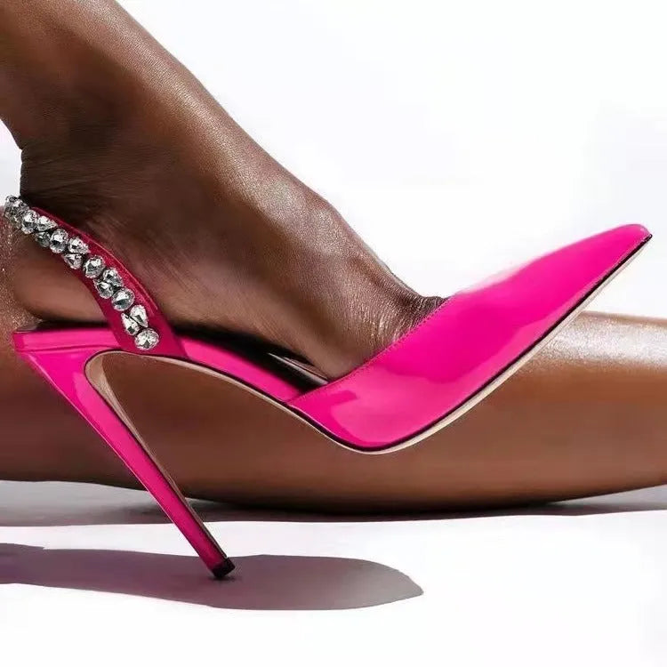 Women's black patent leather pointed toe high heel sandals with rhinestone details on the strap.