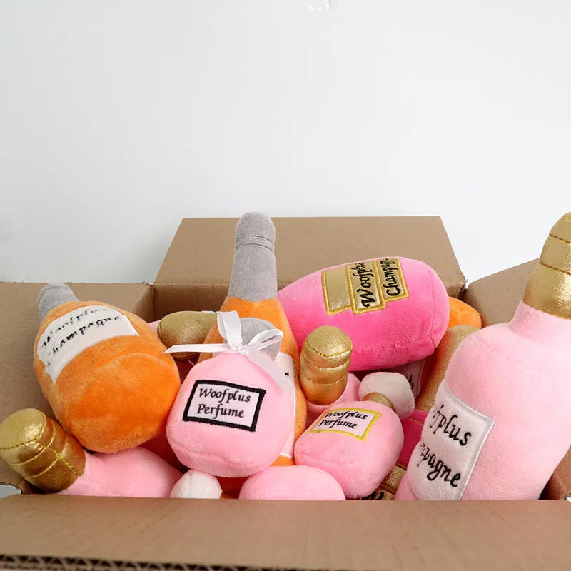 Soft plush pet toy shaped like a wine bottle, shown in various colours including green, red, and black.