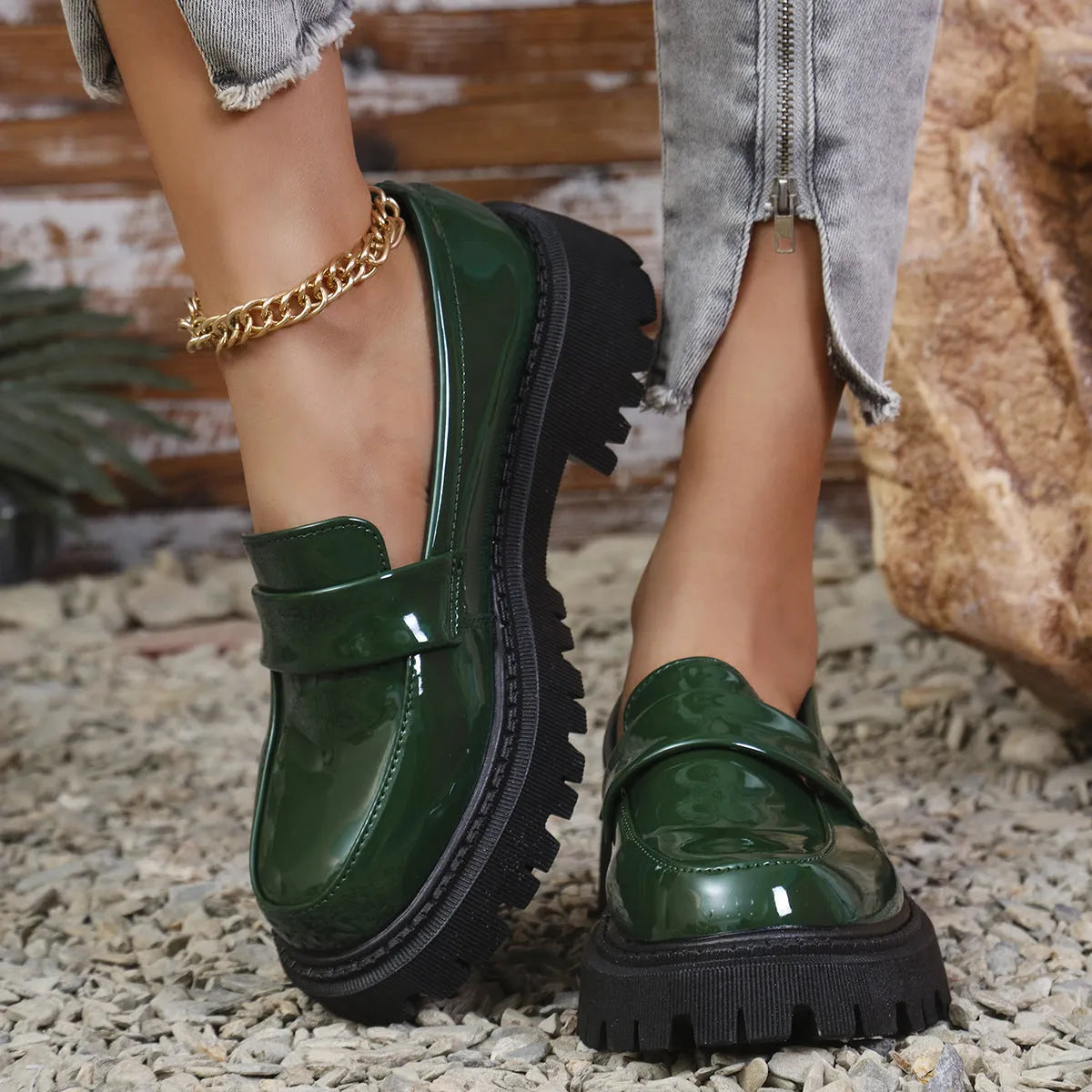 Plus size women's black slip-on loafers with a chunky platform heel and rubber sole.