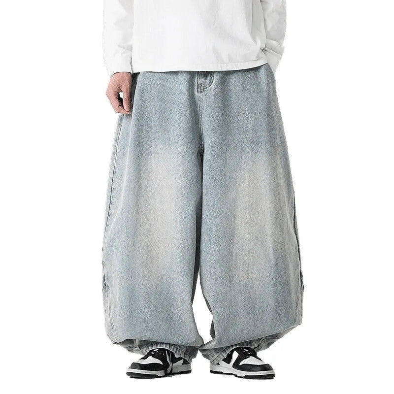 Man wearing black plus-size baggy denim jeans with a straight leg and low waist.