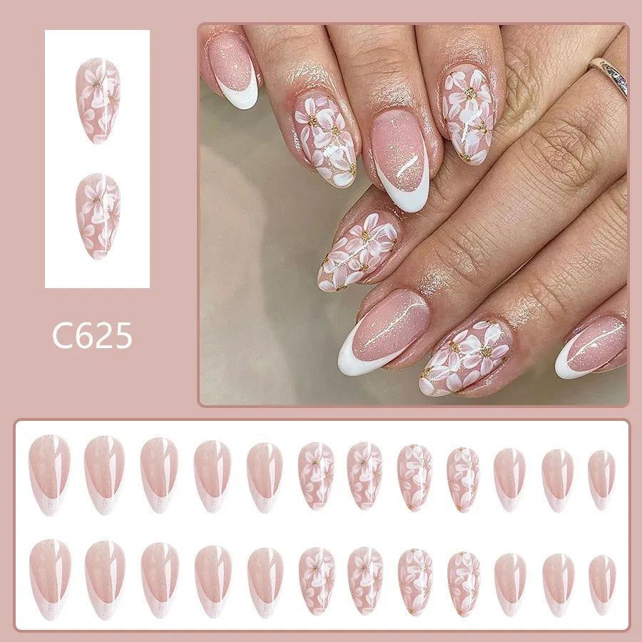 Short almond artificial nail tips with French manicure and glitter flower design in C625 colour