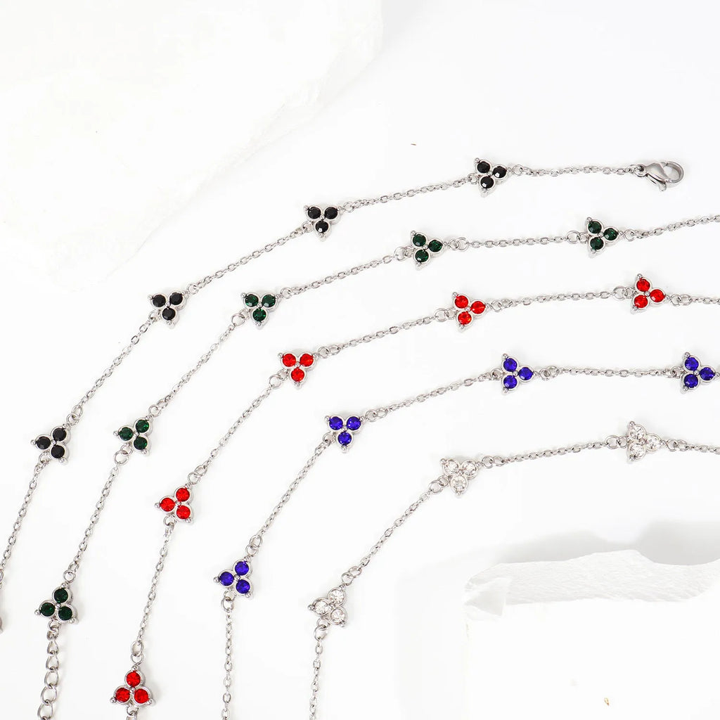 Geometric triangle bracelet for women in stainless steel with coloured zircon stones.