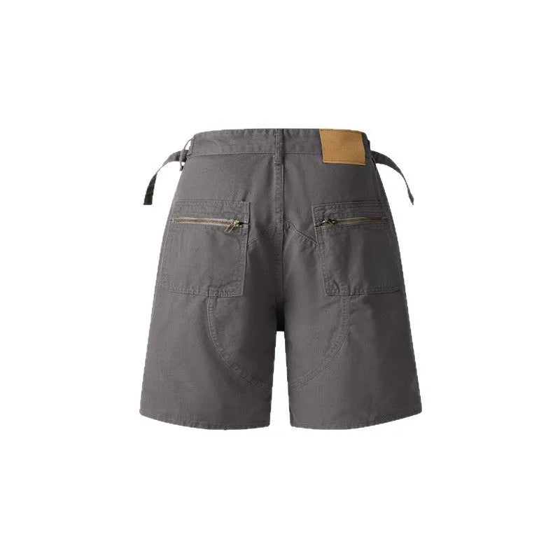 Retro loose-fit workwear shorts in washed cotton fabric with a zipper fly, shown in camouflage colour.