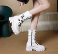 Women's black mid-calf knight boots with a large metal buckle and side zip fastening