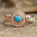 Women's turquoise geometric square ring with inlaid zircon stones on a rose gold band.
