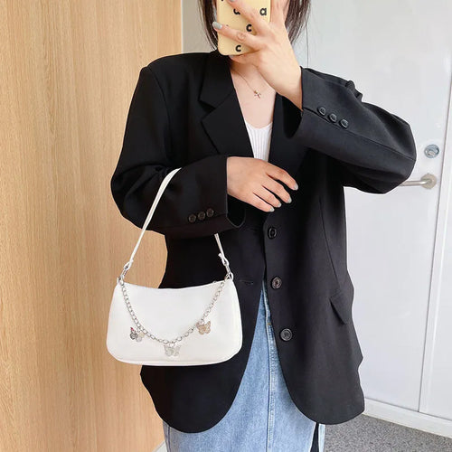 Butterfly chain underarm bag in horizontal square shape with detachable strap and organised interior