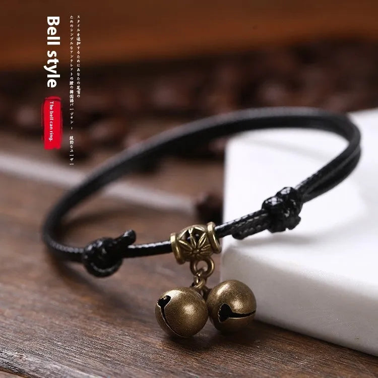 Adjustable nylon dog collar with brass bell on black rope, shown alongside red and coffee colour options.