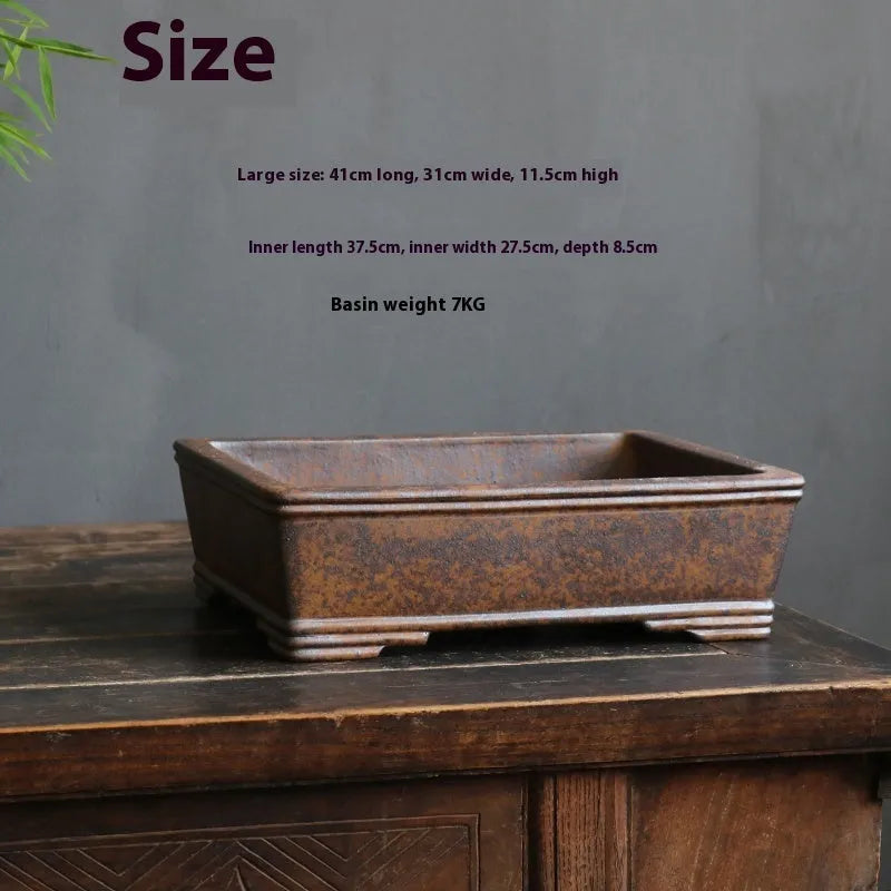 Rectangular purple sand bonsai planter with firewood burning finish and pine cypress boxwood decoration