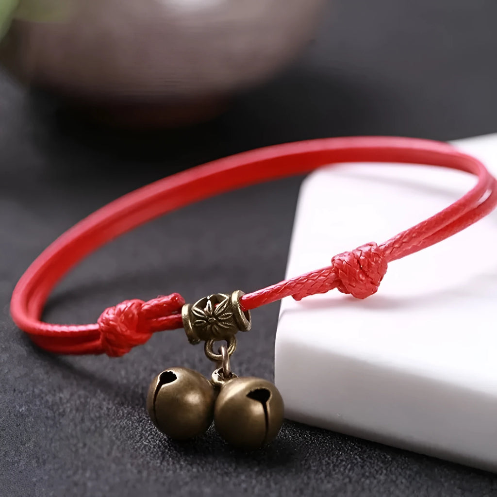 Adjustable nylon dog collar with brass bell on black rope, shown alongside red and coffee colour options.