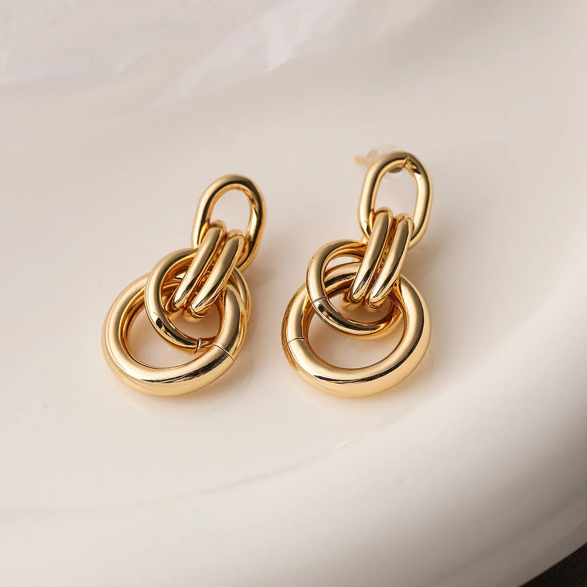 Gold-colour geometric earrings with irregular shapes and INS high-profile design