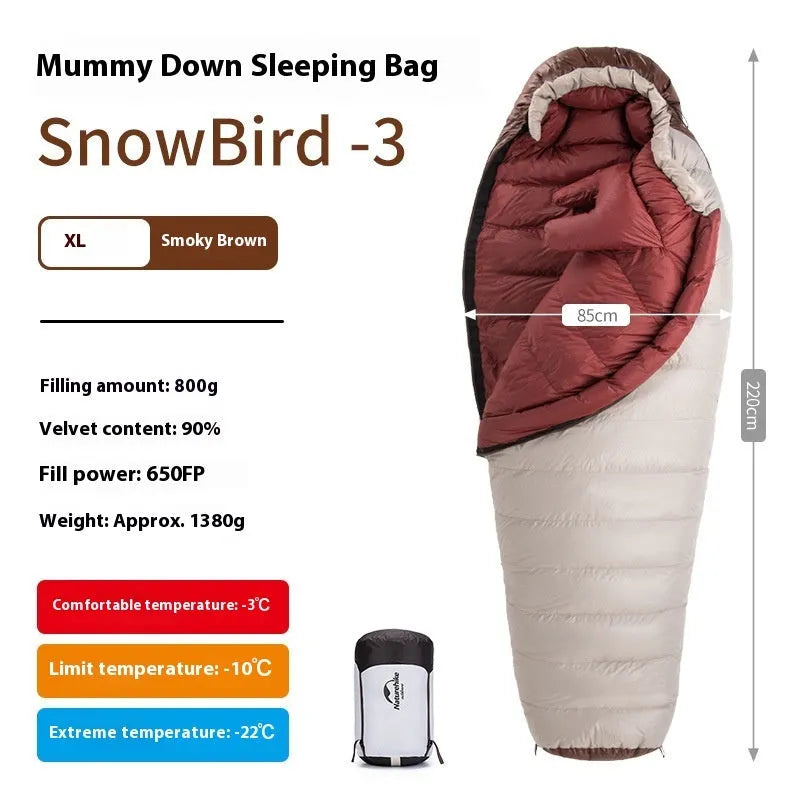 Mummy style goose down sleeping bag for adults shown with its storage bag