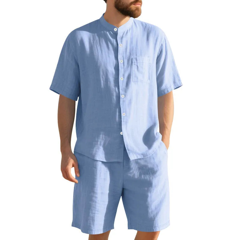 Men's light blue linen two-piece suit with short-sleeved henry collar shirt jacket and shorts on a hanger.