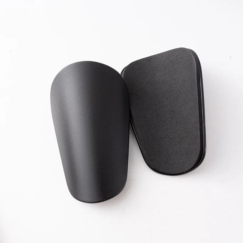 PU mini shin guards in various colours on a leg, showing S and XS sizing for sports protection.