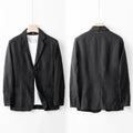 Men's casual linen suit jacket in a solid colour on a hanger, showing long sleeves and loose fit.