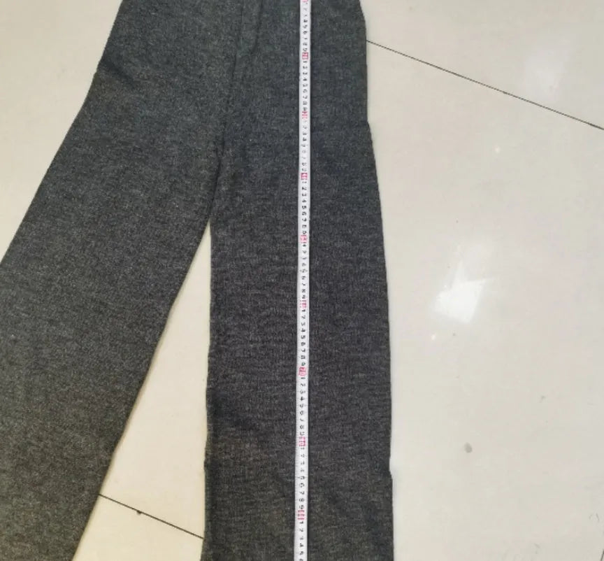 Women's dark grey acrylic jumper suit with side slits on the top and matching trousers.