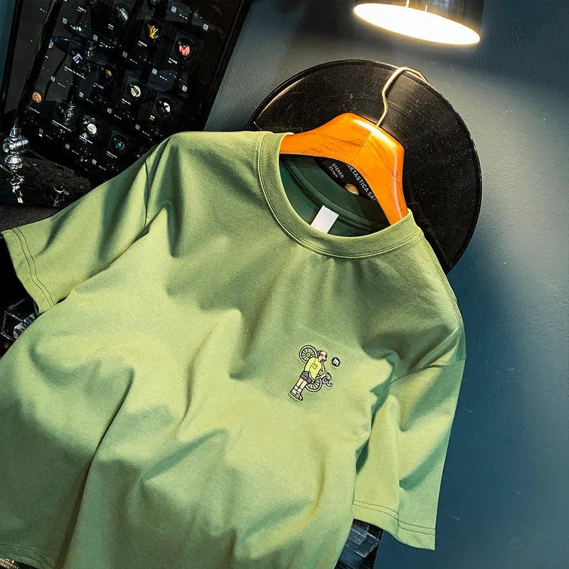 Green men's loose fit T-shirt with printed design on front, short sleeves