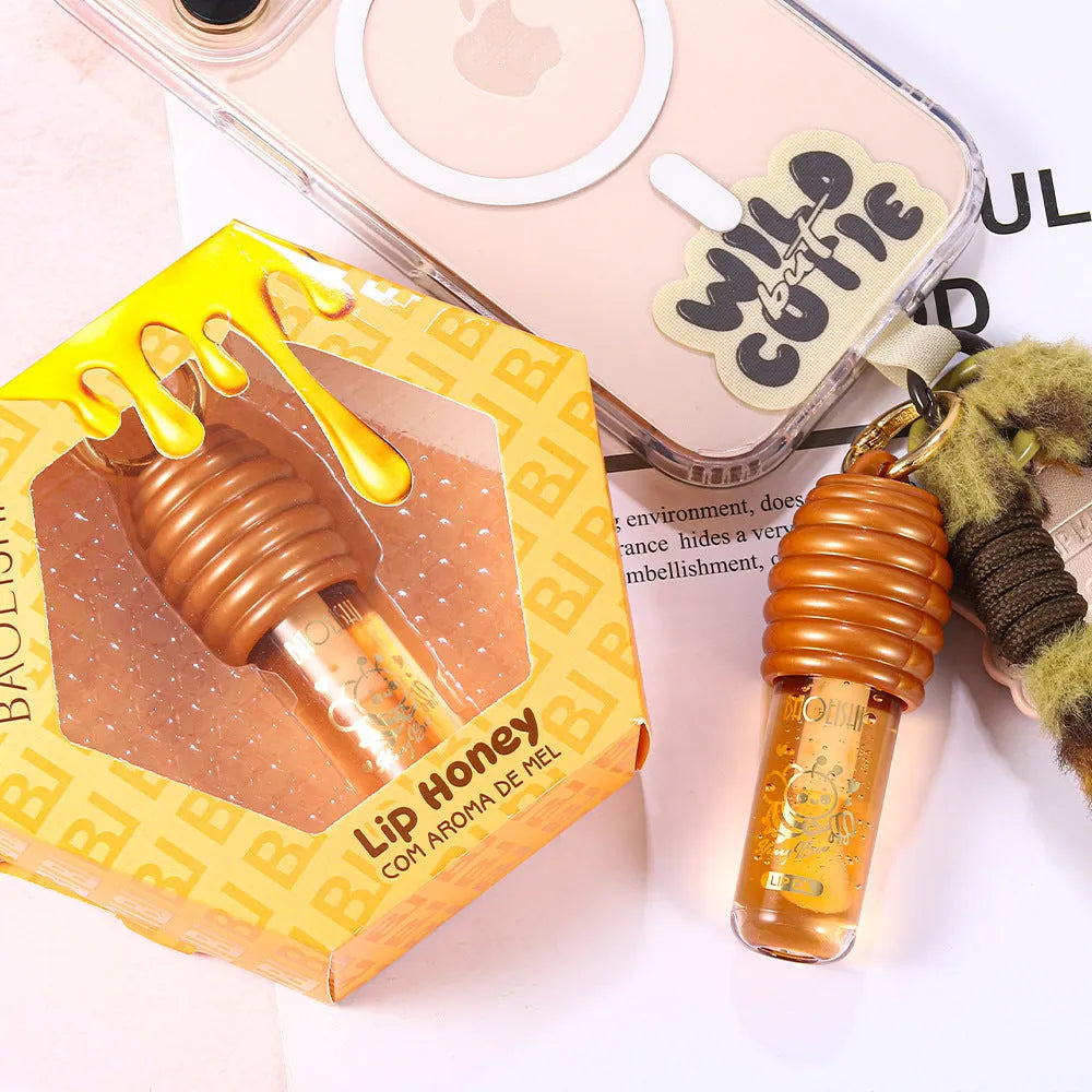 Honey-coloured lip gloss with keychain attachment for portable carrying on bags