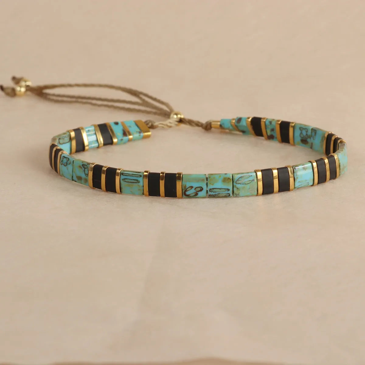 Geometric glass pull bead bracelet in milky white, black, green, blue or red with round decorative elements