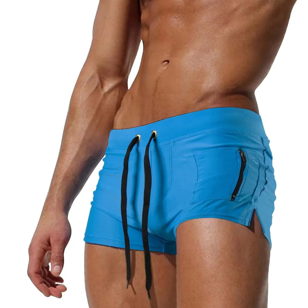 Men's high-waist lace-up polyester swimming trunks in solid colour on mannequin.