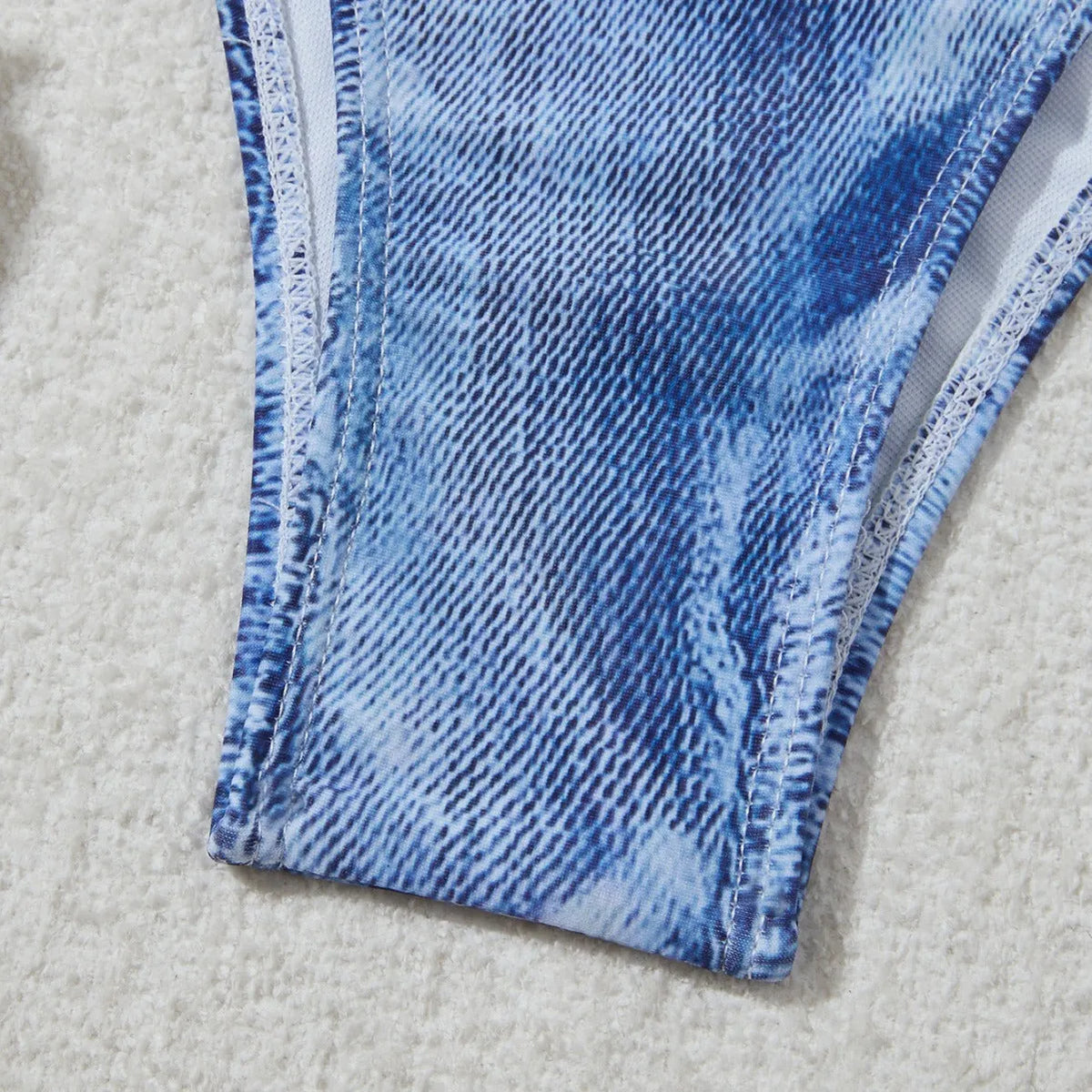 Denim blue women's bikini set with printed design and strap detail, sizes S to XL.