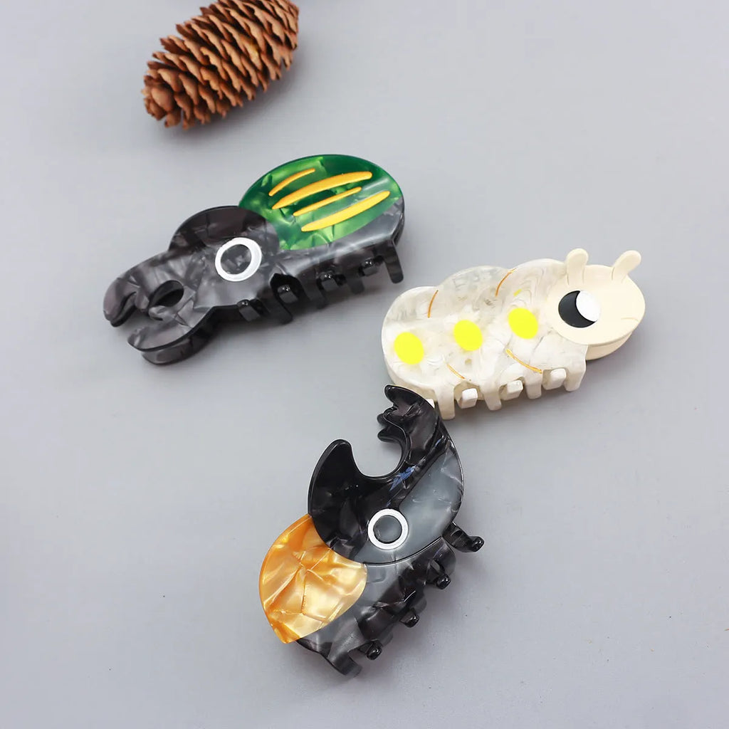 Handmade cellulose acetate Beetle Grip insect biology teaching tool with cartoon caterpillar design