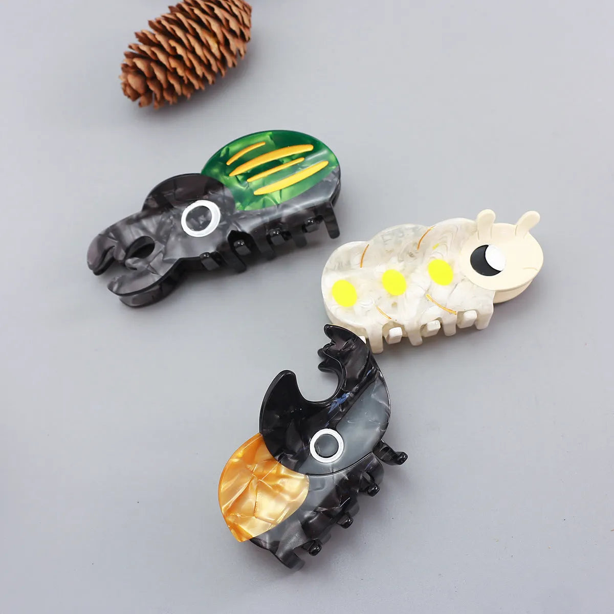 Handmade cellulose acetate Beetle Grip insect biology teaching tool with cartoon caterpillar design