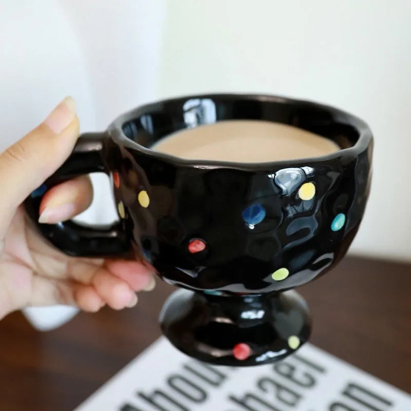 Irregular shaped hand-pinched ceramic mug in solid colour showing unique contours and modern design