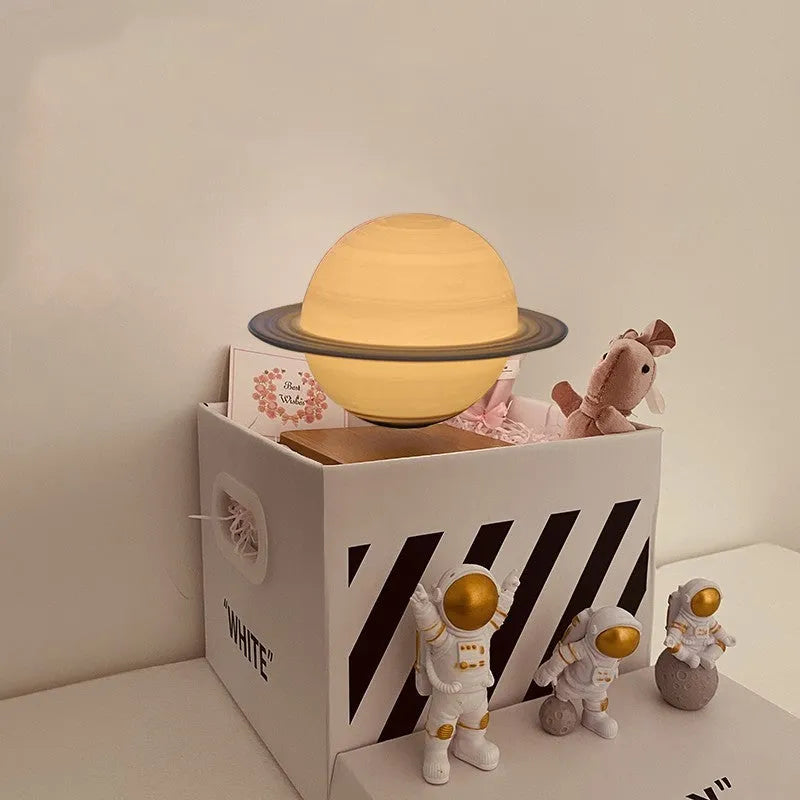 Maglev Moon Earth planet night light floating above base with LED glow, next to astronaut figurines.