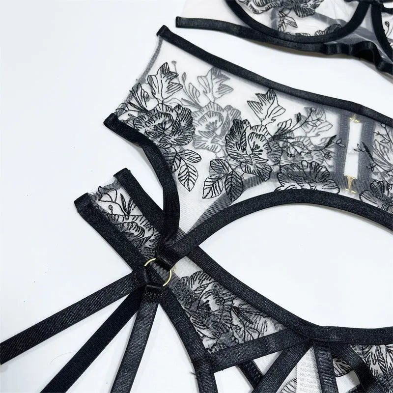 Women's black lace mesh three-piece set showing crop top, high-waist pants and waist ring with floral print