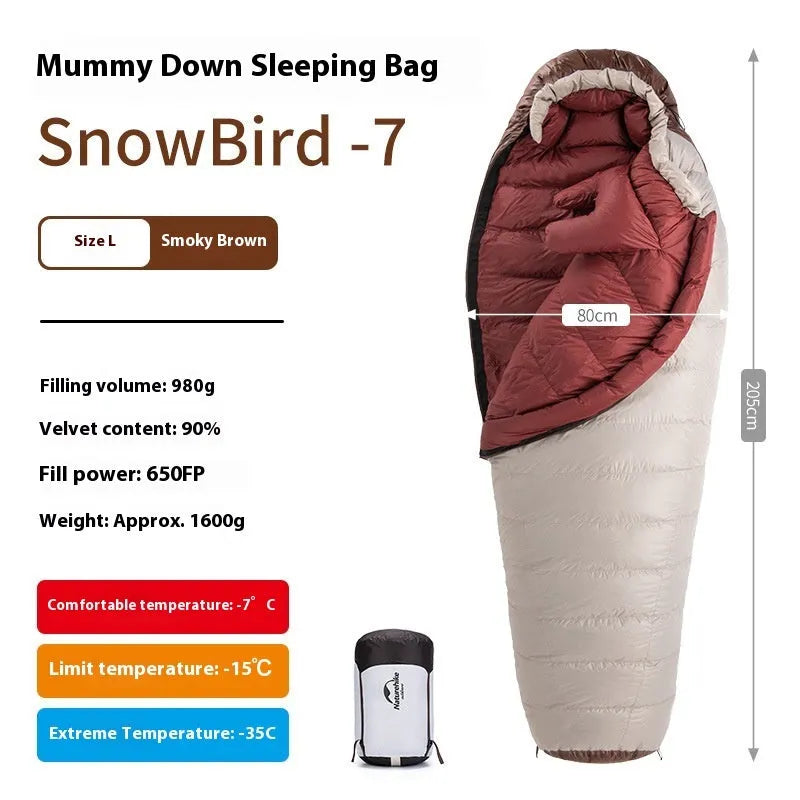 Mummy style goose down sleeping bag for adults shown with its storage bag