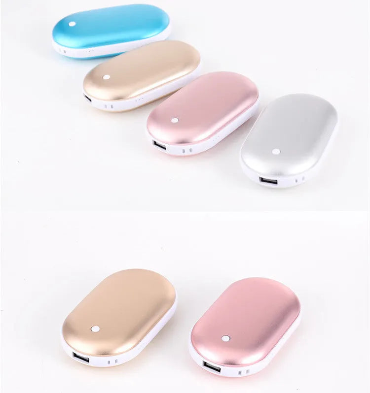 Compact rose gold rechargeable hand warmer and power bank with USB port on a table.