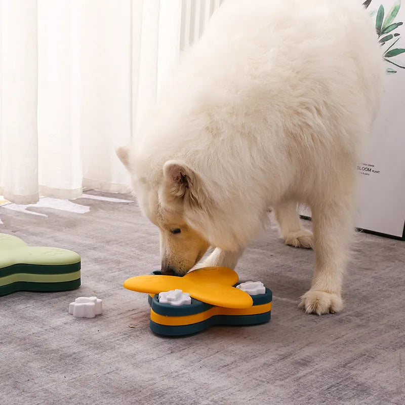 Green and yellow dog puzzle toy with rotatable compartments and bone-shaped covers