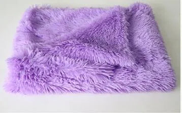 Soft long plush dog blanket in dark grey, sizes S M L shown next to a large dog.
