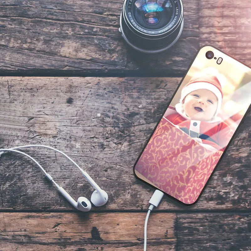 Slim patterned iPhone case with raised edges protecting a smartphone.