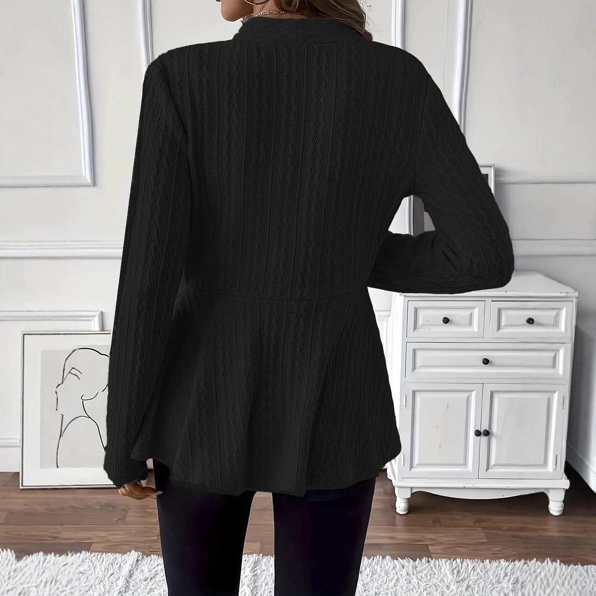 Women's apricot knitted cardigan with one button and jacquard pattern on a hanger.