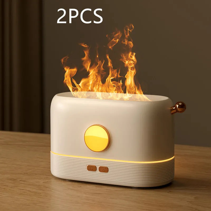 Black USB desktop humidifier diffuser with glowing simulated flame effect on a wooden table.
