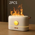 Black USB desktop humidifier diffuser with glowing simulated flame effect on a wooden table.