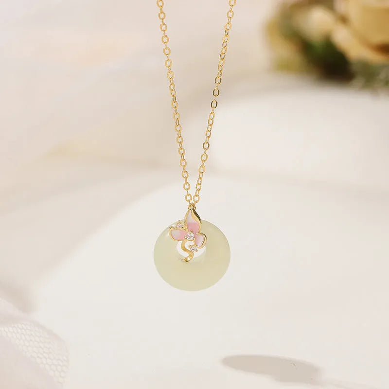 Silver orchid pendant necklace with geometric details and a safety buckle on an O-ring chain.